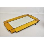 An Art Deco wall mirror with stepped frame and yellow/orange tinted outer border, 66 x 41cm.