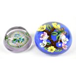 WILLIAM MANSON; two glass paperweights including butterfly and floral detail, signed WM to cane,