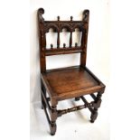 A Derbyshire/Yorkshire oak back stool in the 17th century manner with carved top rail, later plank