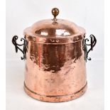 An Art & Crafts copper coal bin and cover with applied handles, drops and planished decoration,