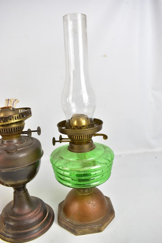 Four vintage oil lamps, one with green glass reservoir, one all brass and one with amber tinted - Image 5 of 5