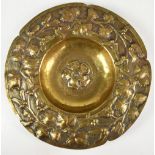 An Arts & Crafts brass bowl with repoussé decoration of a central Tudor Rose and further floral