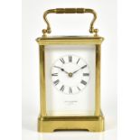 A late 19th century French brass carriage clock, the white enamel dial set with Roman numerals