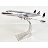 A modern decorative polished aluminium model of an aeroplane on swept base, length 51cm.