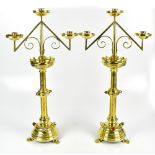 A good and large pair of Arts & Crafts brass ecclesiastical candelabra with detachable three-light