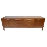 JENS RISOM DESIGN LTD; a mid-century American walnut sideboard, with an arrangement of six central