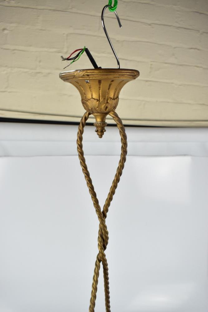 A gilt metal ceiling light modelled as Eros suspended by ropes carrying opaque floral moulded - Image 3 of 3