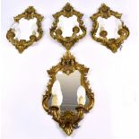 A set of four gilt twin branch girandoles with foliate and scrolling detail, all electrified, 53 x