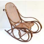 A stained beech and bentwood rocking chair with cane back and seat.Additional InformationCane work