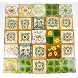 Twenty-seven late 19th century transfer and relief decorated floral motif tiles, comprising a set of
