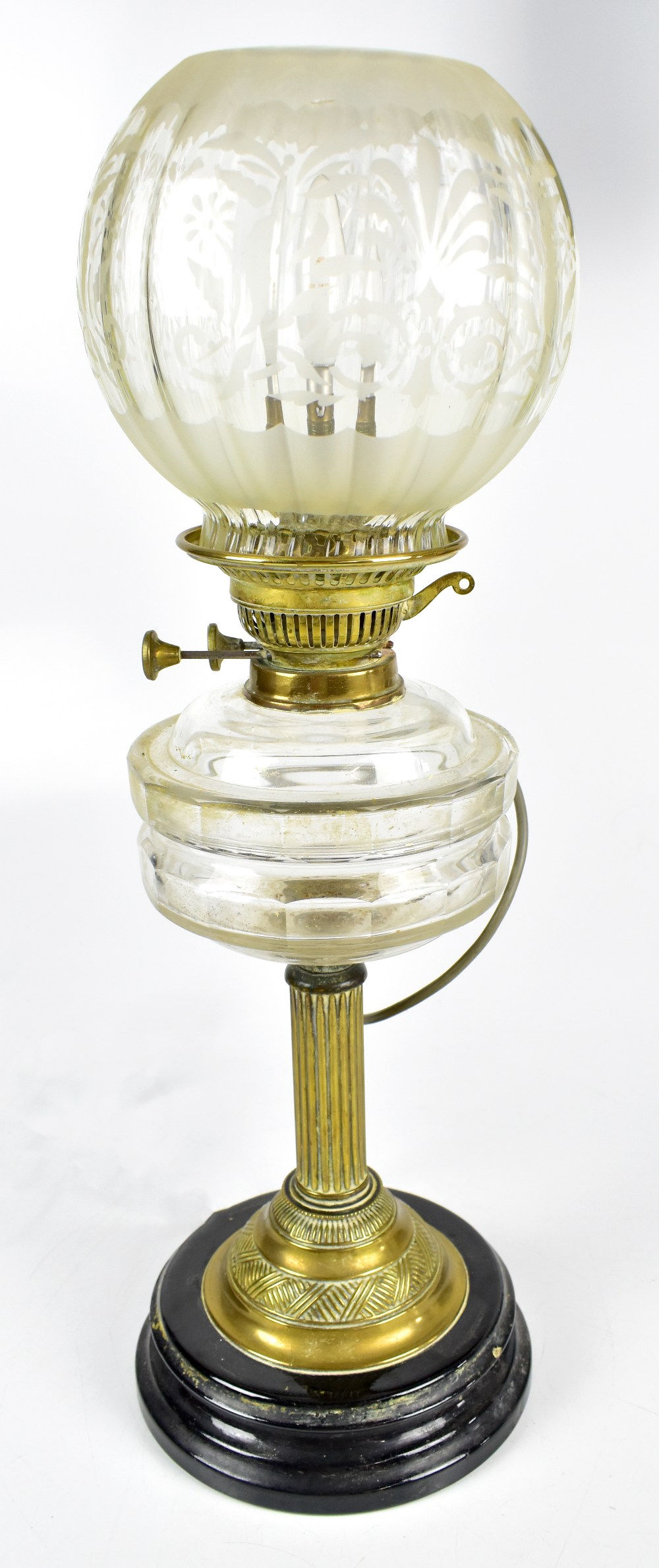 A late 19th century oil lamp with clear glass reservoir and frosted glass shade, height 56cm (
