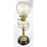 A late 19th century oil lamp with clear glass reservoir and frosted glass shade, height 56cm (