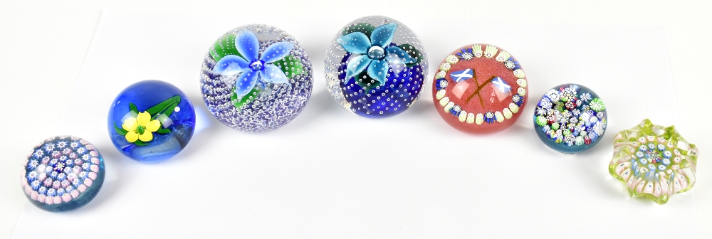 JOHN DEACONS; seven glass paperweights including millefiori example, bubble examples with floral