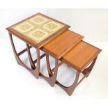 G PLAN; a nest of three graduated teak framed coffee tables, the larger example with four inset