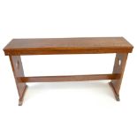 An Arts and Crafts oak bench with carved love heart side panels, length 118cm.Additional