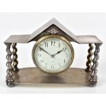 ALBERT EDWARD JONES (BRITISH, 1878-1954); an Arts & Crafts pewter mantel clock with planished