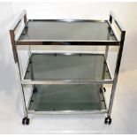 A chromed and smoked glass three tiered tea trolley, width 61cm, height 71cm, depth 37cm.