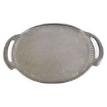 ENGLISH PEWTER; an Arts & Crafts pewter twin handled tray with planished decoration to the centre