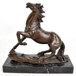 A modern reproduction cast bronzed metal figure of a horse, raised on marble plinth base, height