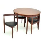 HANS OLSEN FOR FREM ROJLE; an extending teak dining table, diameter unextended 105.5cm, and a set of