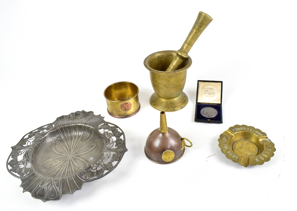 A brass pestle and mortar, a copper funnel, an Art Nouveau pewter dish (af), an advertising Tyler'