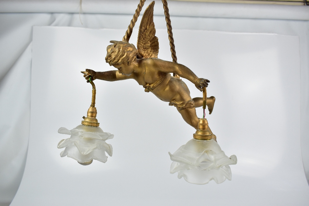 A gilt metal ceiling light modelled as Eros suspended by ropes carrying opaque floral moulded - Image 2 of 3