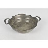 GSW; an Art Nouveau embossed pewter twin handled bowl decorated with stylised leaves, impressed