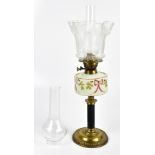 An Edwardian brass oil lamp with painted opaque glass reservoir and etched glass shade, with two