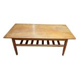 A Danish teak mid-century rectangular coffee table with under tier magazine shelf and impressed