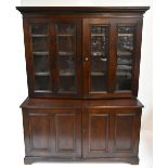 A large early 20th century stained pine school cabinet, the upper section with moulded cornice above