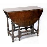 A late 17th/early 18th century oak gateleg table with pegged oval top with ruled edge,
