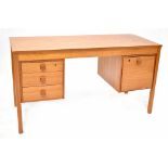 A contemporary kneehole desk, three drawers to one side, one filing drawer to the other, 75 x 134cm.