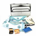 A Crown grey attaché case containing a quantity of Masonic regalia to include an apron, gloves,