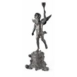 An ebonised bronze figure of a cherub holding aloft a torch,