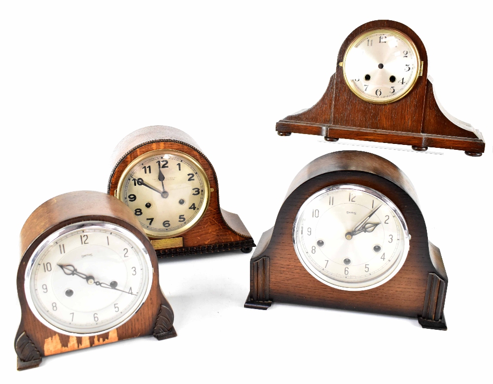 Four early/mid-20th century oak and mahogany cased clocks to include a Smiths eight-day chiming