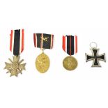 A WWII German Bronze War Merit Cross with remains of packet of issue, a War Merit Medal in Bronze,