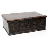 A 17th century oak Bible box with moulded lid which reveals a plain interior with candle box,