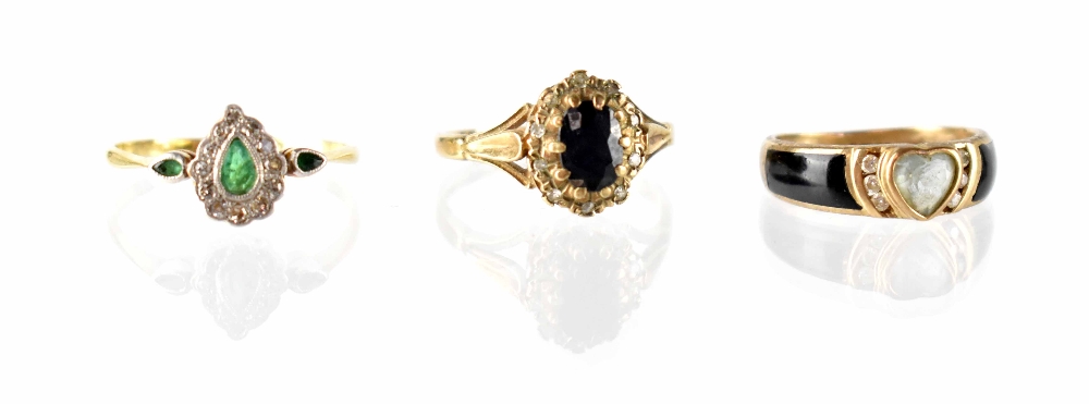 Three 9ct gold fashion rings to include an emerald and diamond heart ring with two tiny emeralds to