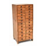 An early 20th century pine twenty-four drawer apprentice cabinet on block supports, 70 x 31cm.