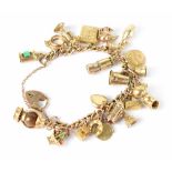 A 9ct gold charm bracelet with twenty-three gold charms, gold heart clasp and safety chain,