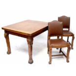 An early/mid-20th century oak dining suite comprising draw leaf table to Oriental style legs,
