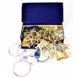 A quantity of costume jewellery to include necklaces, brooches, etc.