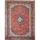 A hand-knotted Persian Kashan (Iranian) carpet, red ground, classic floral with central medallion,