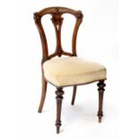 A Victorian walnut dining chair with pierced splat back and carved decoration,
