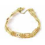 An Edwardian-style 15ct gold diamond and sapphire gate bracelet,
