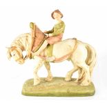 A Royal Dux figure of a boy riding a heavy horse, impressed number 1693 to base and impressed marks,
