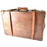 An early 20th century brown leather travel trunk, initialled FWS and ACCRA,