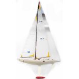 A large cream pond yacht with Union Jacks and Continental flags, large sails,