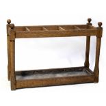 A late 19th/early 20th century five-division oak stick stand with tin drip tray, length 89cm,