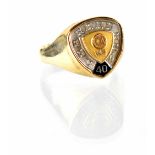 A gentlemen's yellow and white metal dress ring with shield top, marked to interior 14K.